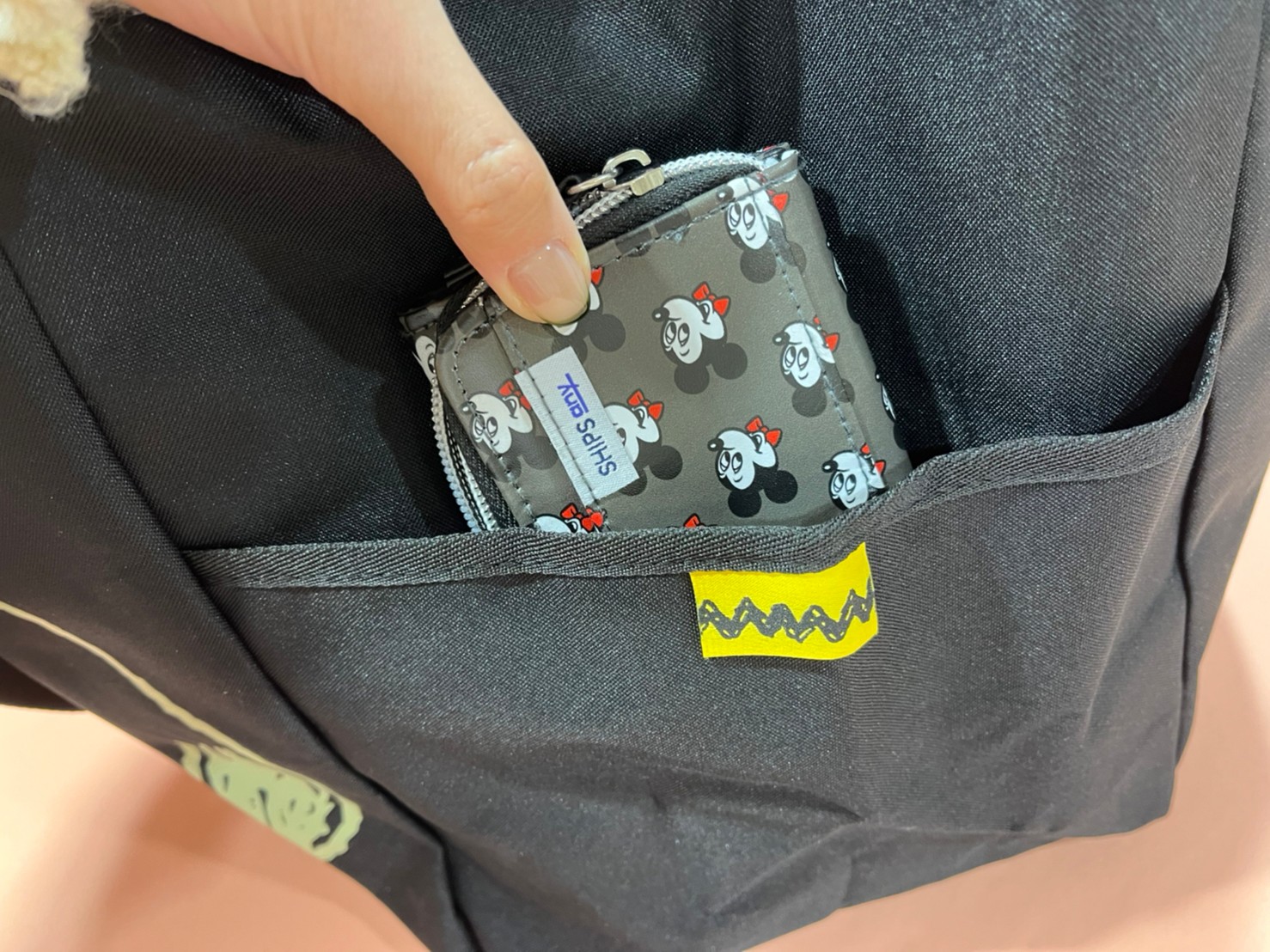 レジカゴサイズトートバッグのサイドポケットにミニ財布を入れる画像