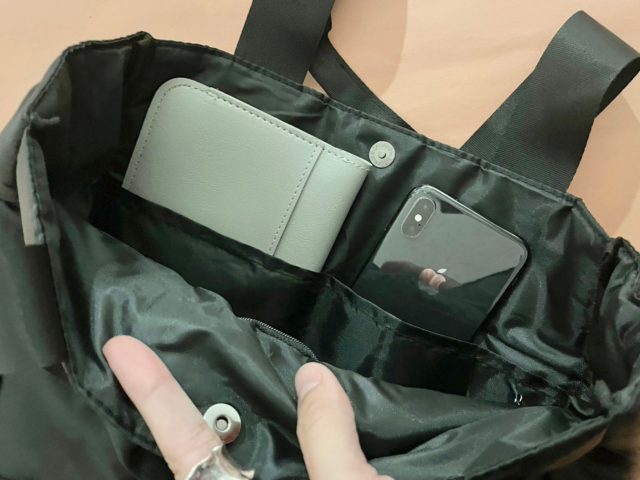 バッグの内ポケットにスマホを入れている